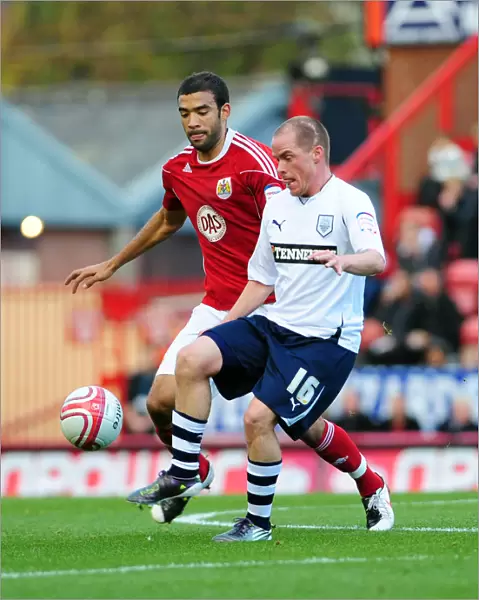 Battling for Supremacy: Liam Fontaine vs. Iain Hume in the Championship Clash between Bristol City and Preston North End