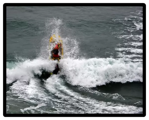 An RNLI lifeguard on a rescue water craft at Perranporth