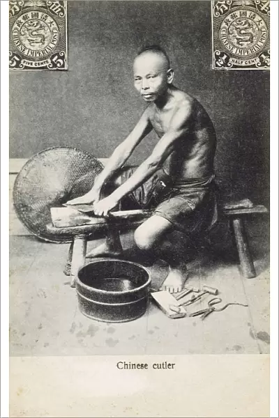 China - A Chinese cutler, sharpening a Chinese Cleaver
