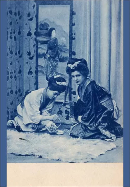 Two European girls dressed as Geishas enact the Tea Ceremony