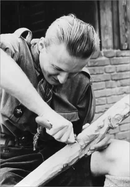 Dutch boy scout carving wood, Holland