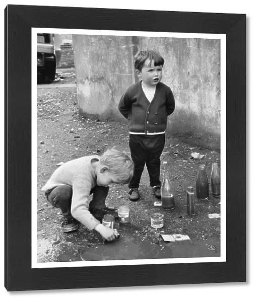 Boys playing in a puddle, Balham, SW London