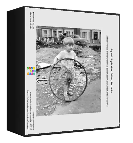 Boy with bicycle wheel, Balham, SW London