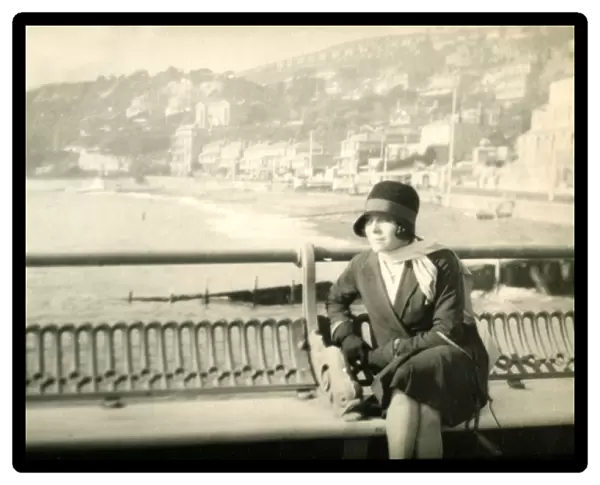 Woman sitting on a bench at the pier