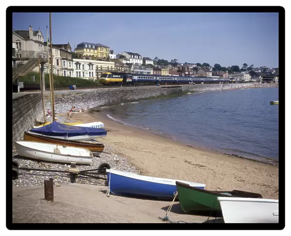 View of cove with boats and train, Dawlish, Devon