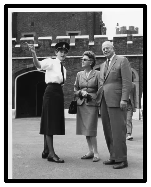 Woman police officer with couple, London