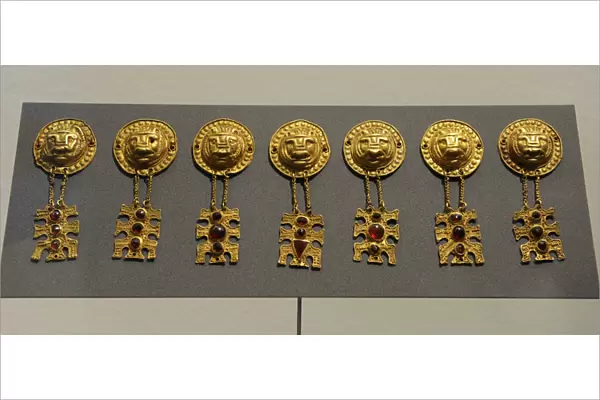 Metal Age. Gold ornaments with lions head. Womans grave fr