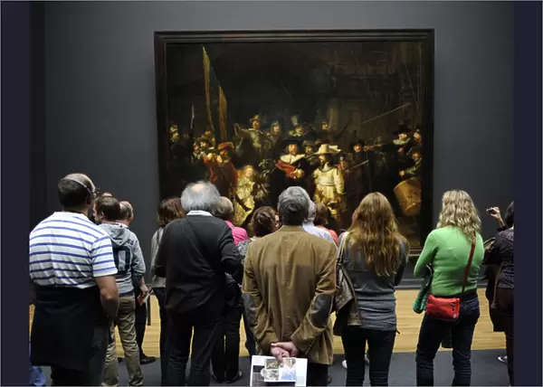 Visitors looking at The Night Watch by Rembrandt (1606-1669)