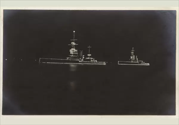 HMS Marlborough and HMS Ajax illuminated at night