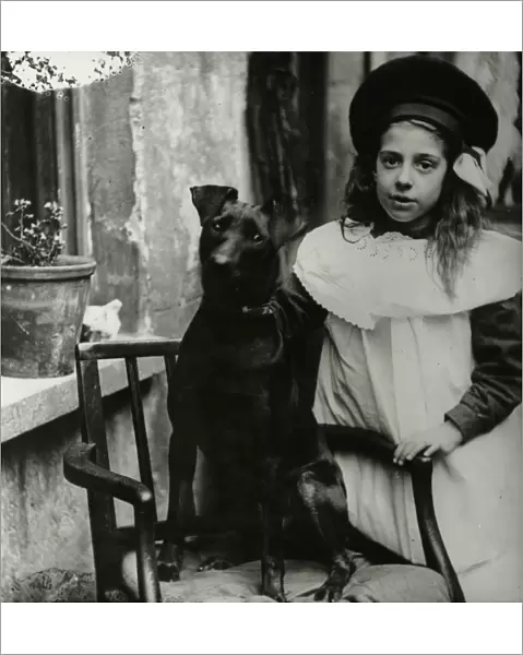 Girl with dog outside a house
