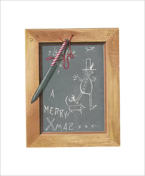 Childs slate with pen and scribbles on a Christmas card