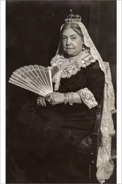 Woman in costume posing as Queen Victoria
