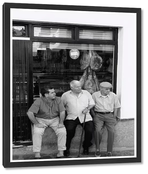 Three men outside shop, Spain