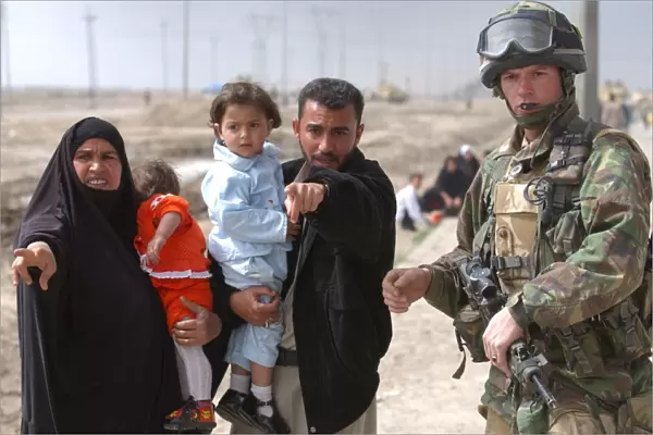 A family of Iraqi civilians seek the help of a soldier