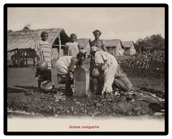 Madagascan women gathering water from a fountain