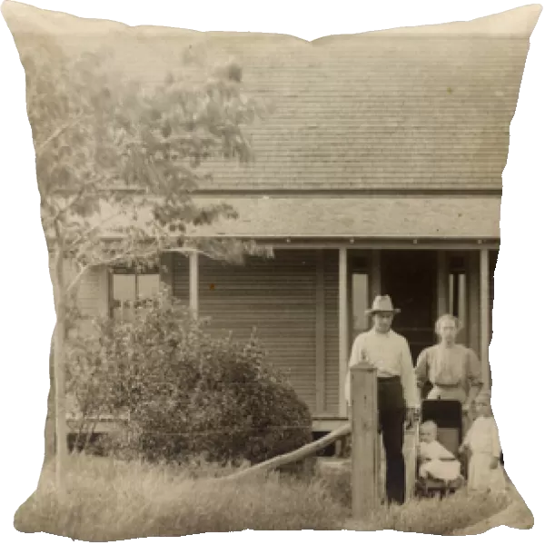 Family of four outside their bungalow-style cabin, USA