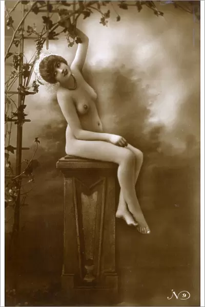French Pin-up girl - seated on a plinth beneath a vine
