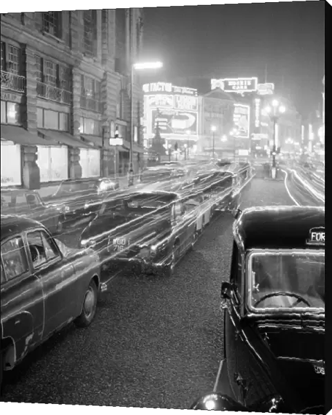 Stationary traffic along a busy Piccadilly at night