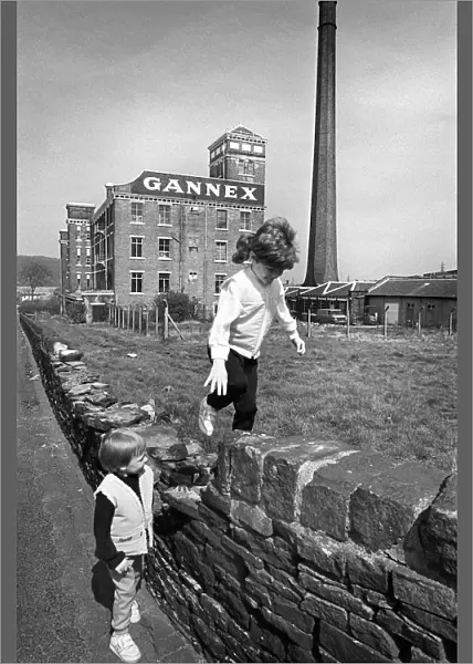 Children play outside the old Gannex factory in Elland
