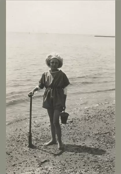 British girl with a bucket and spade - waters edge