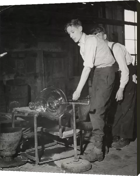 Young men spinning molten glass into a large cut glass bowl at Walsh Ltd