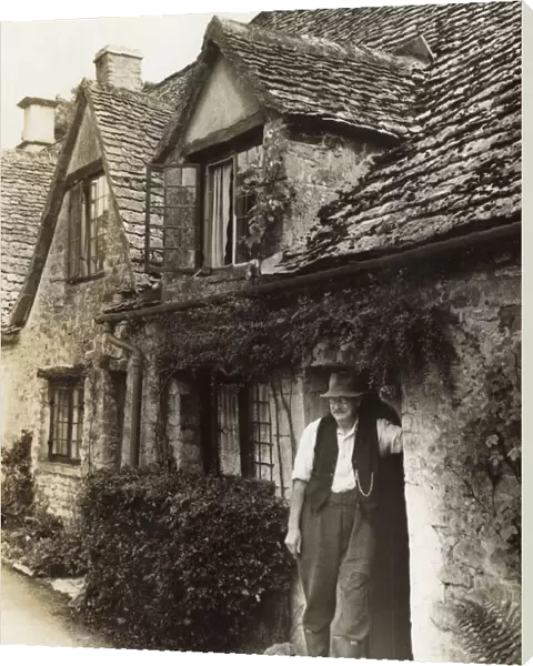 Man in cottage doorway, Arlington Row, Bibury, Glos