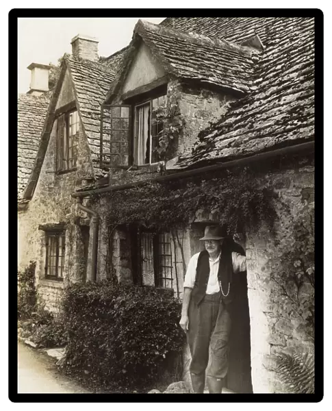 Man in cottage doorway, Arlington Row, Bibury, Glos