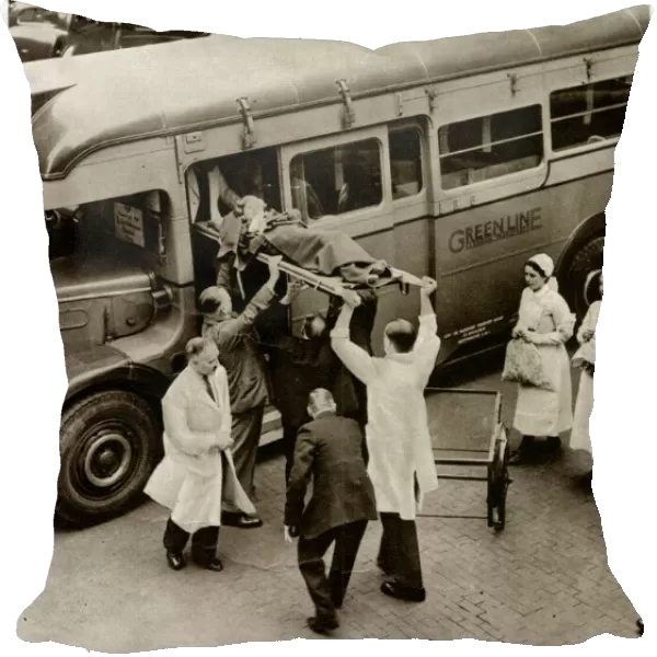 Patient on stretcher lifted onto evacuation coach 1939