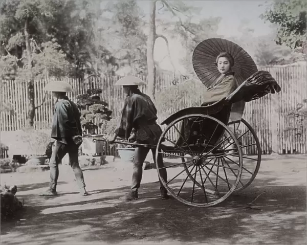 Young woman being pulled in a rickshaw, Japan