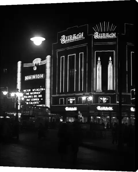 Dominion Theatre and Burton store at night, London