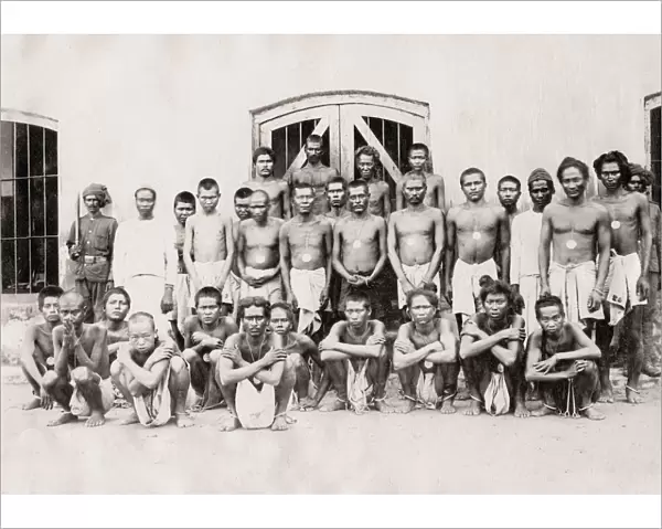 Group of prisoners in shackles, irons, India