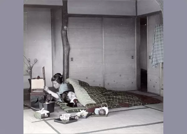 Sleeping under an eiderdown, Japan, c. 1900
