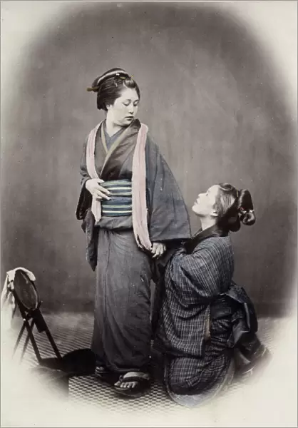1860s Japan - portrait of a young woman tying her obi sash Felice or Felix Beato