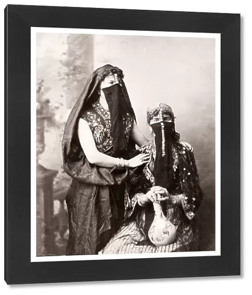 19th century vintage photograph - Egypt - portrait of veiled Egyptian women with a vase