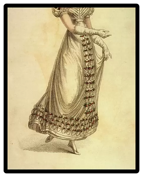 A delightful, white gown with short, full sleeves. The decoration consists of red roses on the sleeves, hemline & in a panel down the front of the skirt. Note the hair comb. Date: 1823