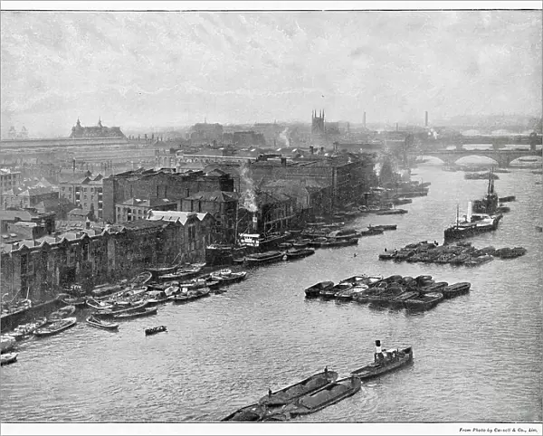 Photograph taken from Tower Bridge of the South Bank of the River Thames at high level. London Bridge, the viaduct which carries the South Eastern and Chatham Railway across the stream from Cannon Street Station