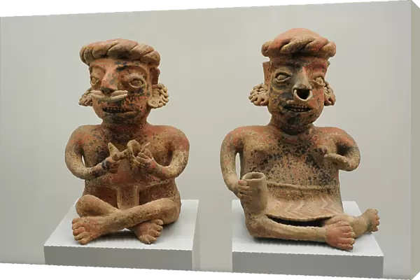 Left to right: seated male figure and seated female figure