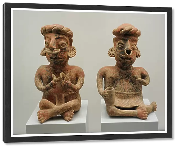 Left to right: seated male figure and seated female figure