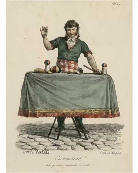 Magician performing trick on table with cup and balls