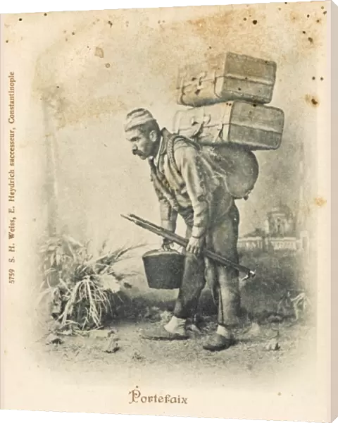 Turkish porter carrying two suitcases
