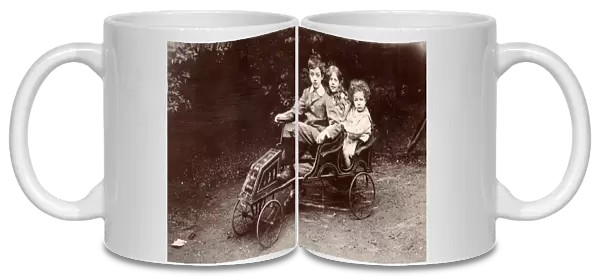 Three children in a toy car