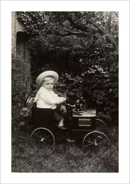 Young boy in an elegant toy car