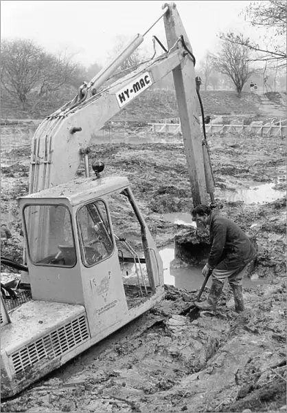 Man with mechanical digger in a muddy field