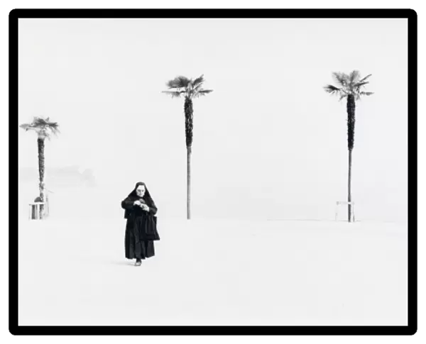 Nun with background of four palm trees