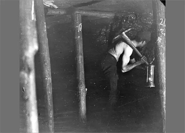 Miner working in a coal seam, South Wales