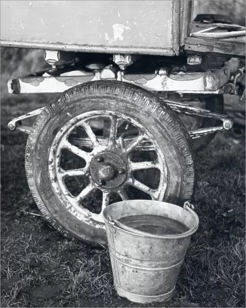 Wheel of gipsy caravan with bucket