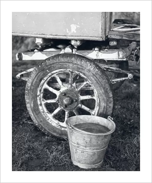 Wheel of gipsy caravan with bucket