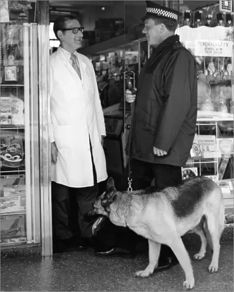 Metropolitan police officer and dog with shopkeeper