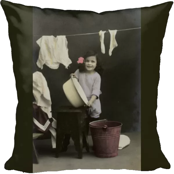 Little girl on a postcard, hanging up the washing