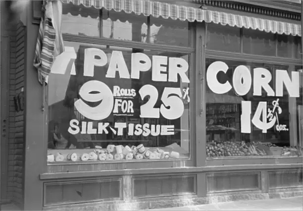 A sign in grocery store window PAPER - 9 rolls for 25 cents